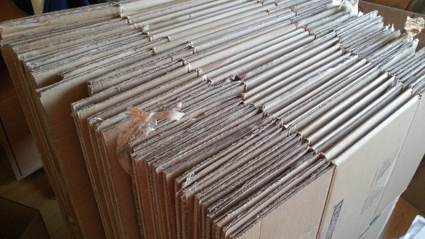 several moving boxes broken down and stacked together, side view