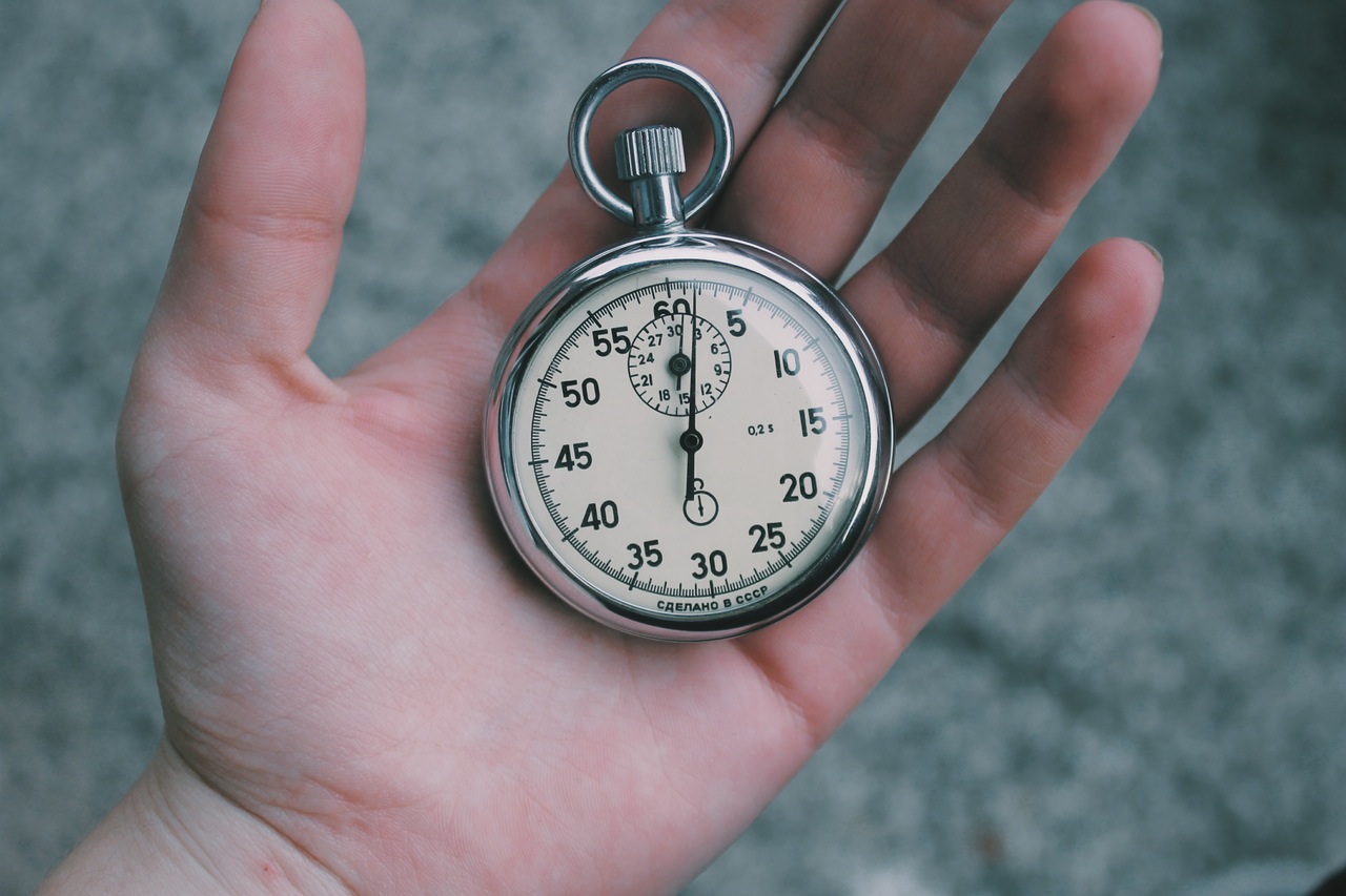close up of hand holding a stopwatch