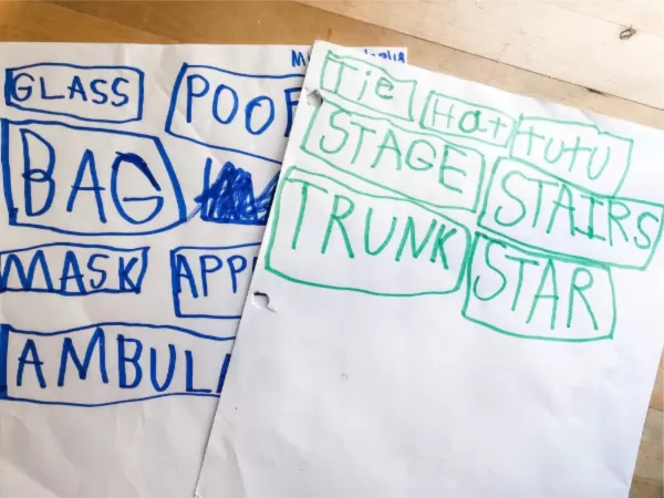 two pieces of paper with words written in child's handwriting, boxes around each word