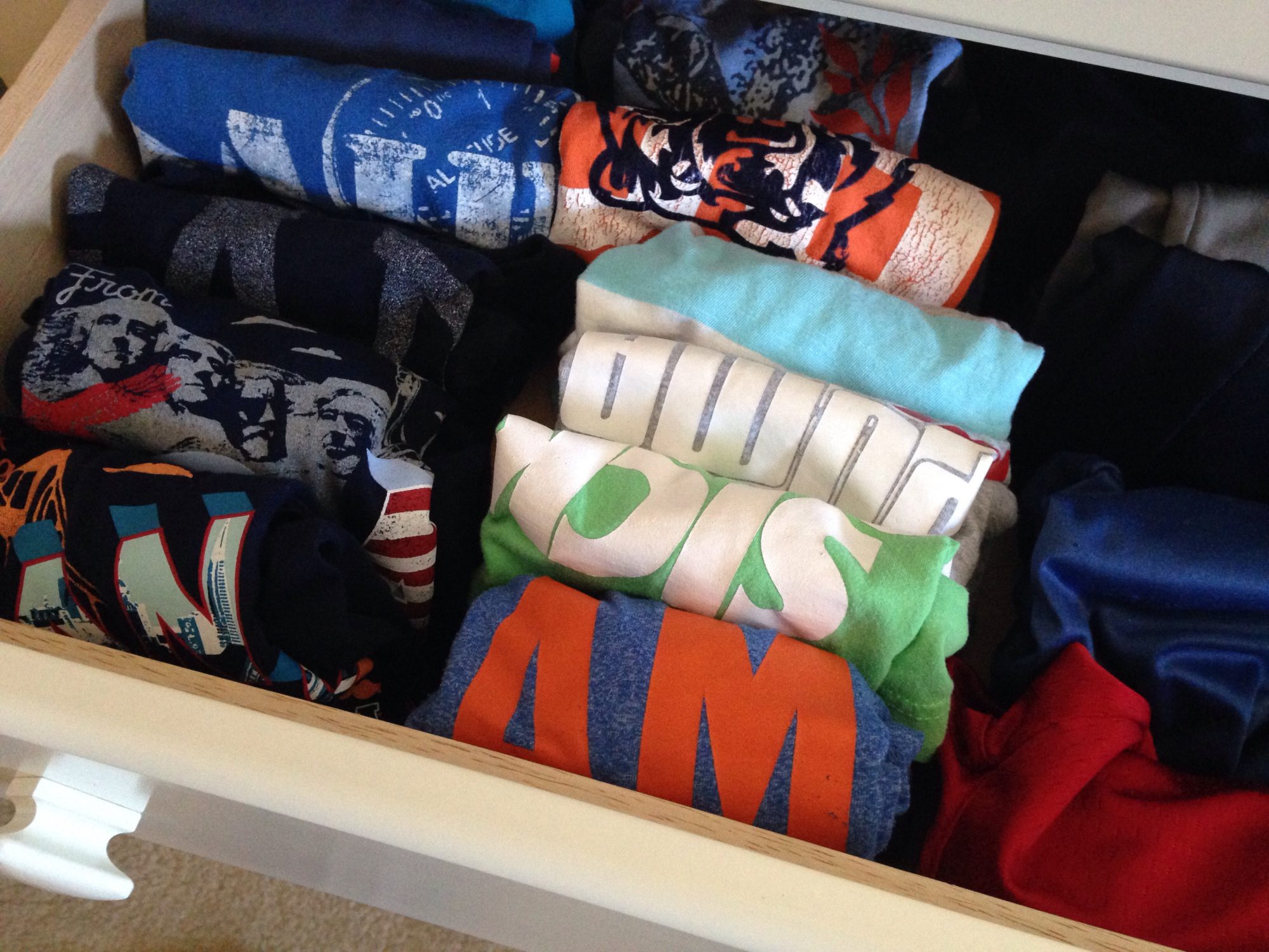boys' t-shirts folded using the Kon Mari method, filed in drawer