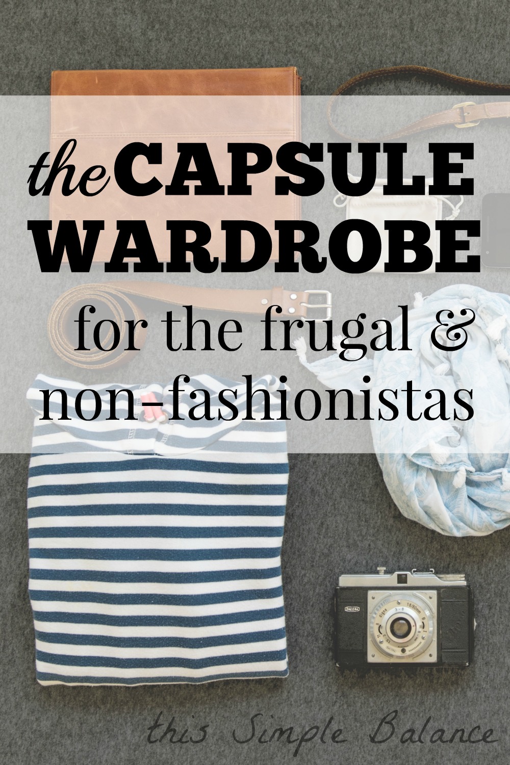 flat lay of capsule wardrobe outfit - folded striped shirt, camera, scarf, belt and leather shoulder bag with text overlay "the capsule wardrobe for the frugal and non-fasionistas"