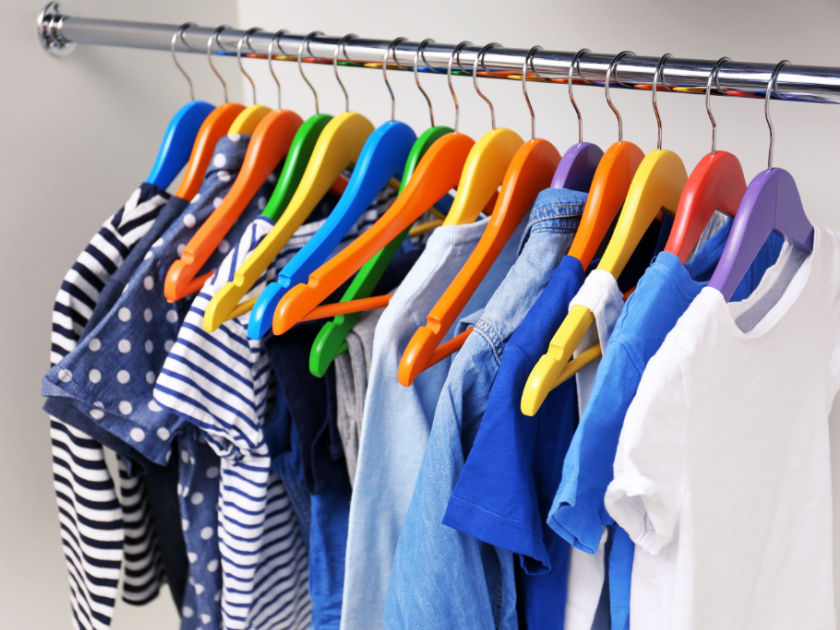 kids capsule wardrobe hanging neatly on hangers in closet