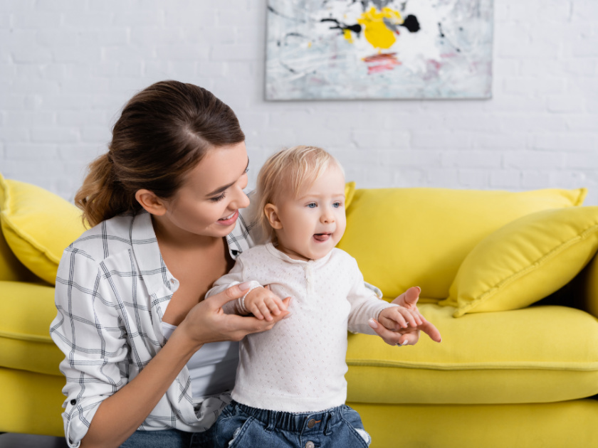 homeschool mom helping toddler walk