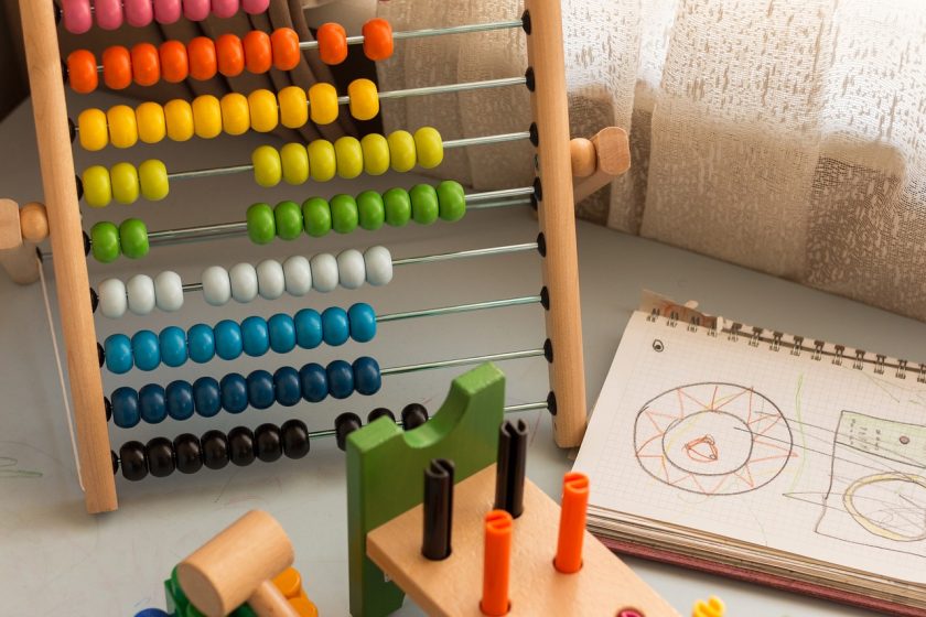 rainbow-colored homeschool math manipulatives on table, including an abacus