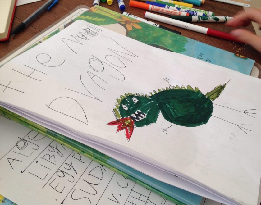 close-up of homeschool child's short story with picture of green dragon breathing fire