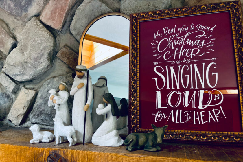 Christmas art print with Buddy the Elf quote and Willow Tree Nativity set on mantel.