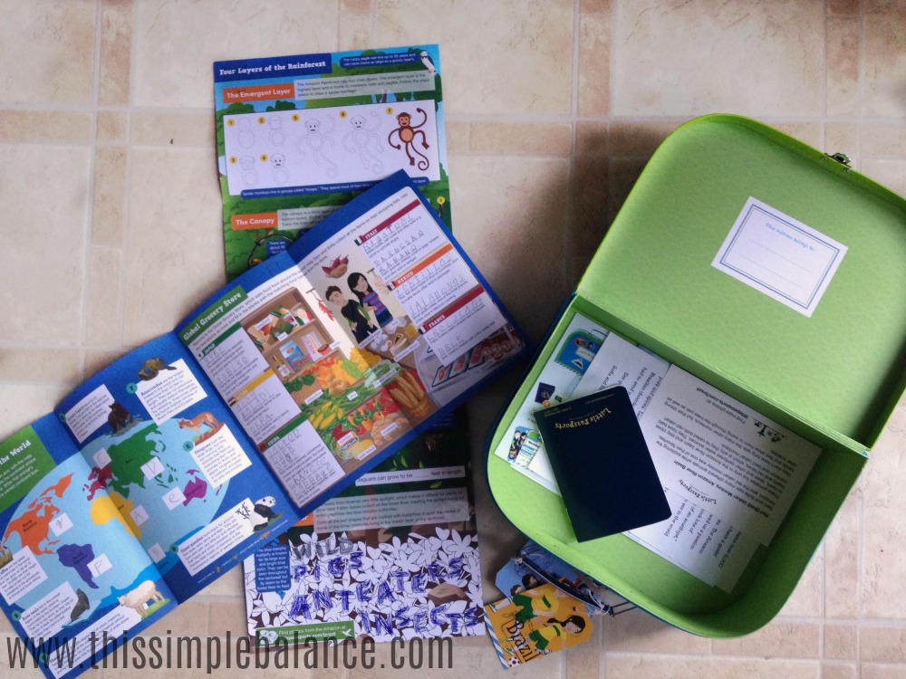 little passports briefcase open with passport and contents of Brazil kit spread on kitchen floor