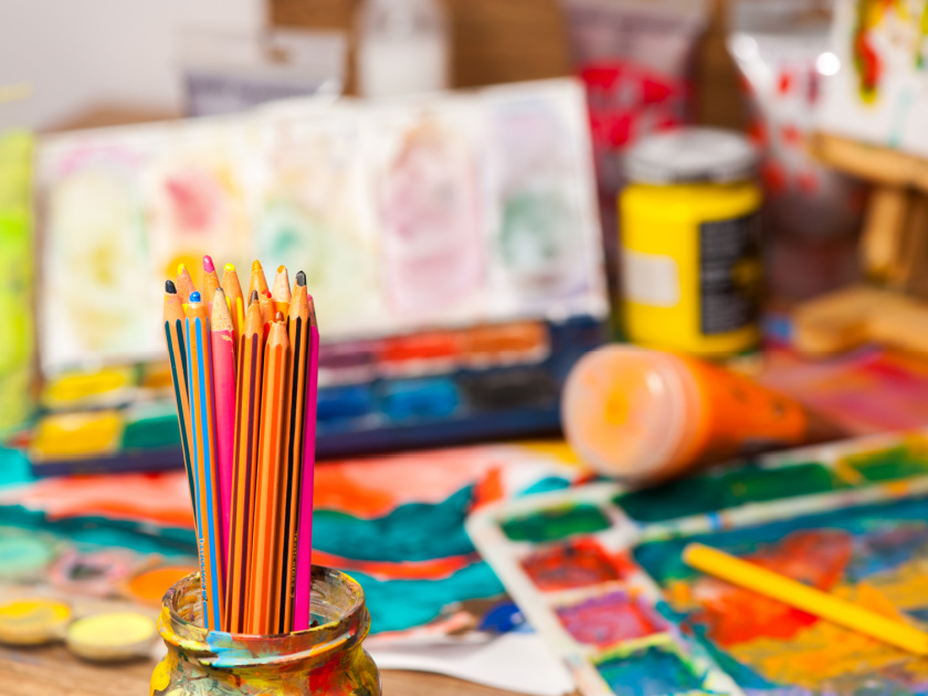 messy homeschool art table with art supplies everywhere