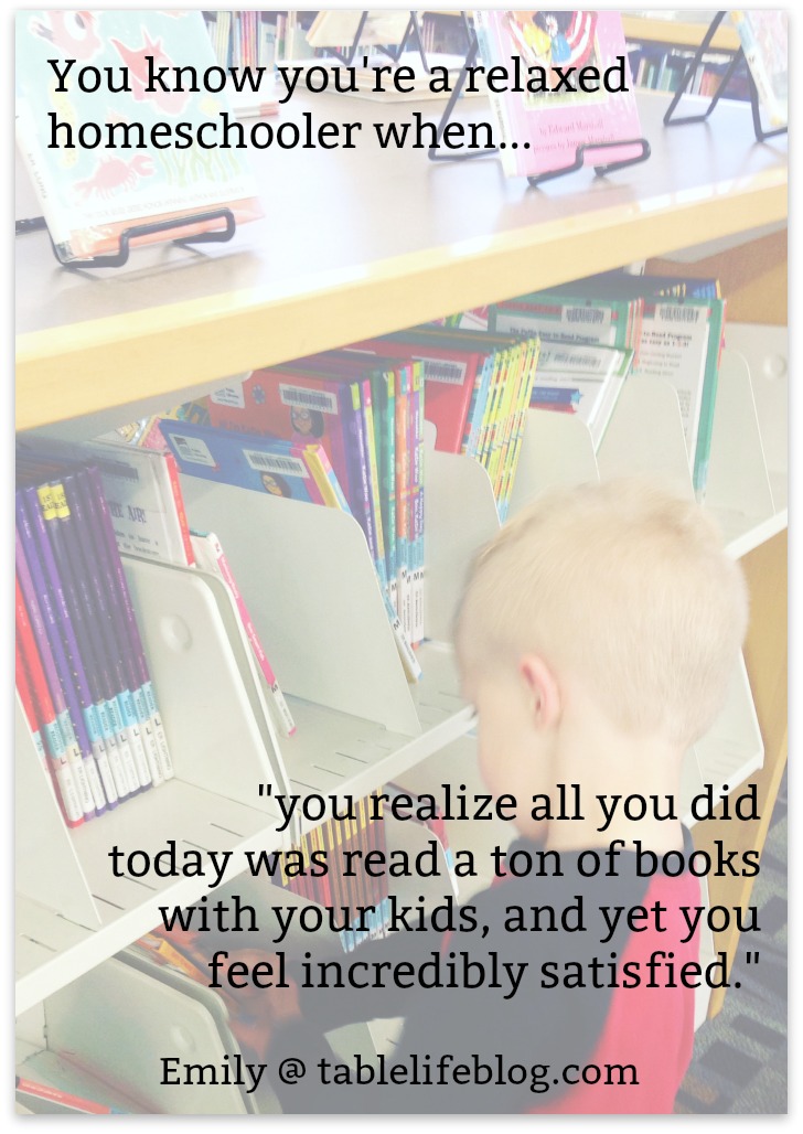 small boy looking at library shelves for books, with text overlay, "You know you're a relaxed homeschooler when you realize all you did today was read a ton of books with your kids, and yet you feel incredibly satisfied." 