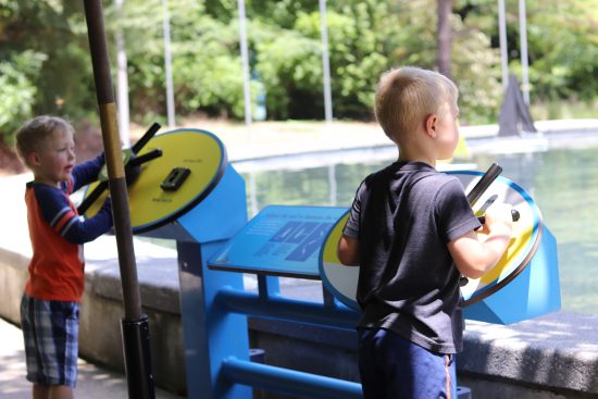 brothers steering sailboats at the Durham Life and Science Museum