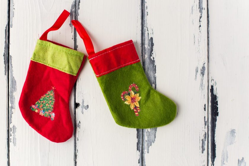 red and green stockings on white wood wall background