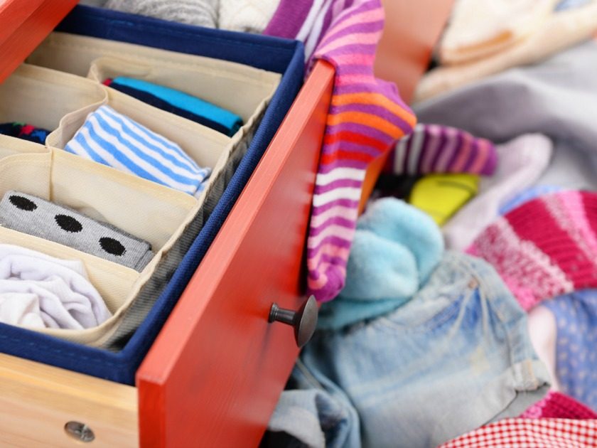 messy drawers open with unfolded clothes