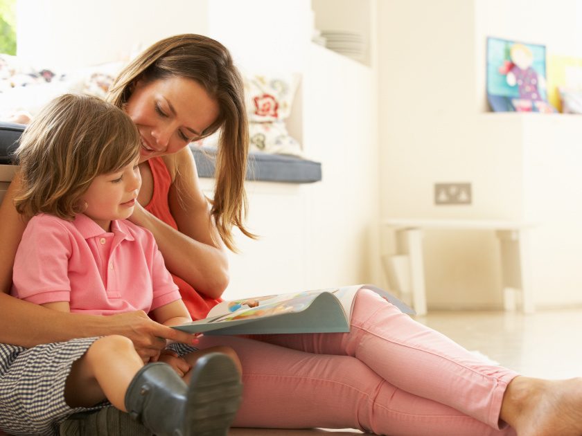 mom homeschooling kindergarten, sitting with child reading