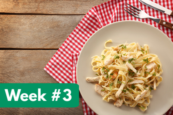 chicken fettucine alfredo on white plate with red and white gingham napkin, with text overlay, "week #3"