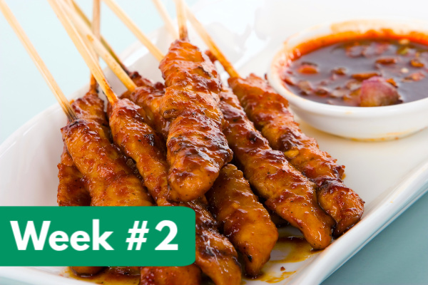 chicken satay on skewers and white tray with dip to the side, with text overlay, "week #2"