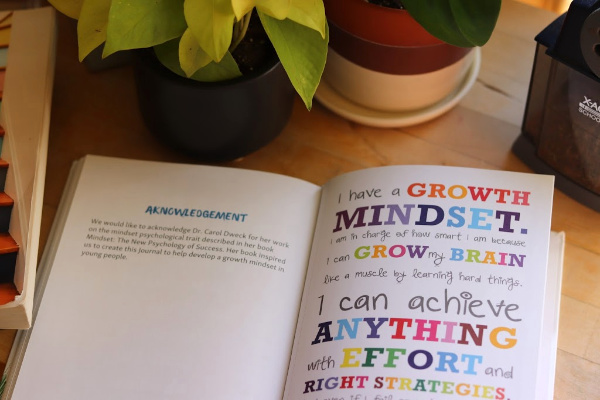 house plants and big life journal first edition opened to quote, "I have a growth mindset..."
