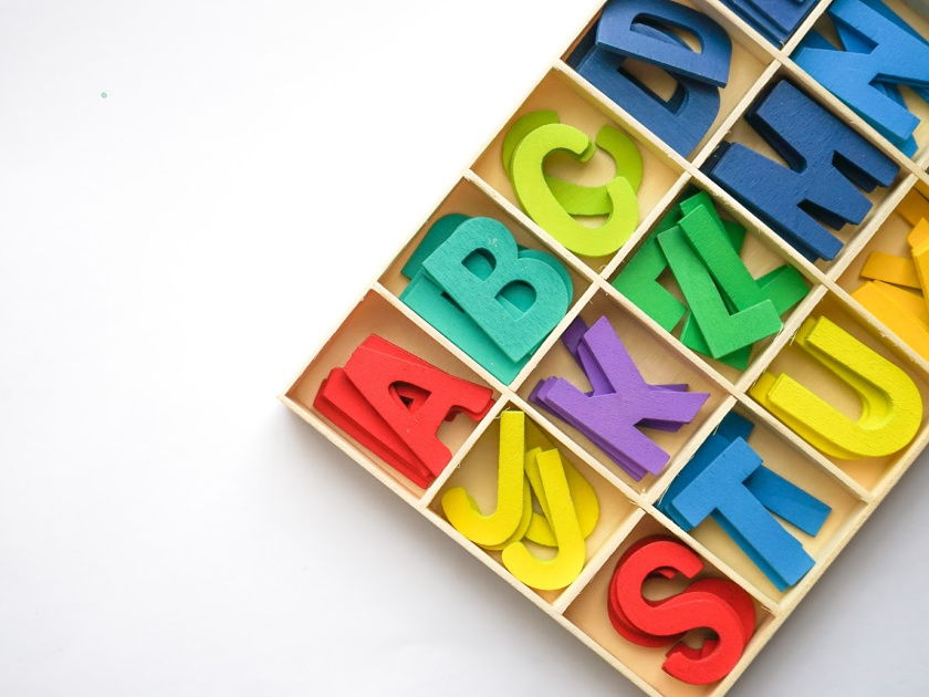 colorful letters sorted by letter in wooden box