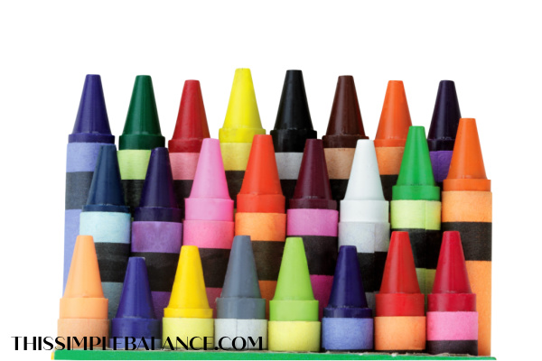 colorful crayons lined up on white background