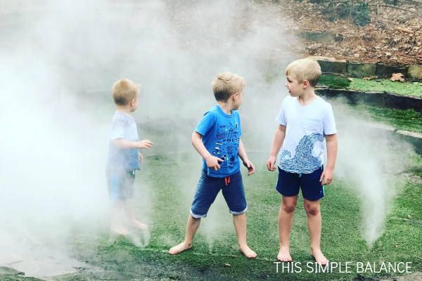 three boys at the misting grounds at Durham Life & Science museum