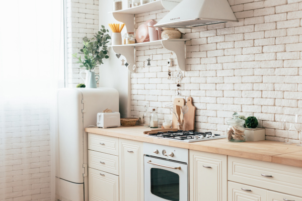 cream-colored tidy kitchen with white brick wall