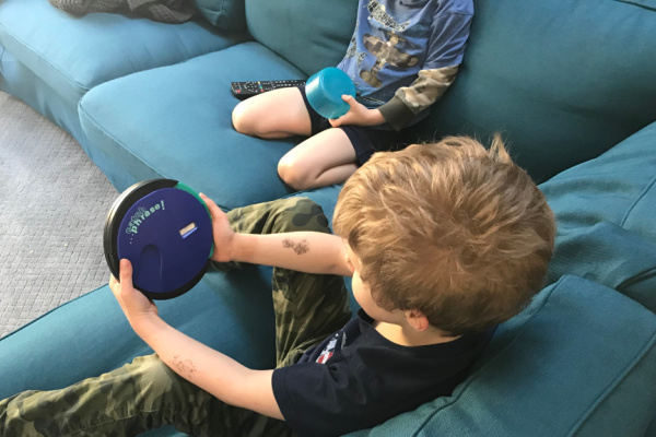 boy playing catch phrase on couch