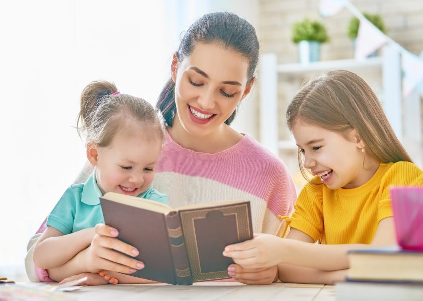 mom reading with two young girls