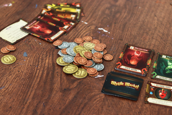mystic market game coins and cards on table