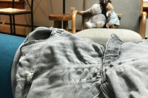 close-up of worn out pair of gray jeans