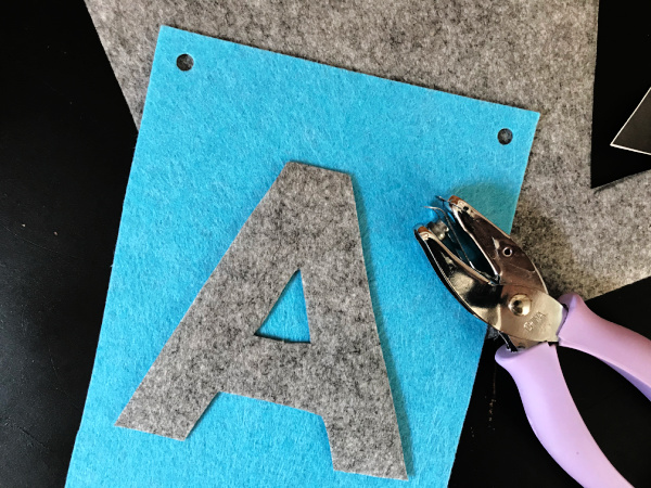 hole punch next to hole punched felt alphabet banner piece