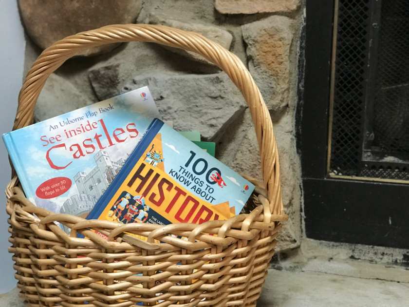 basket on fireplace holding usborne homeschool books