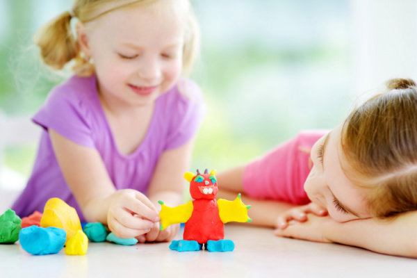 two girls playing with playdoh, playdoh monster on table