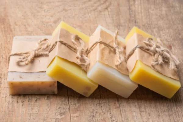 four soap bars wrapped in brown paper and twine