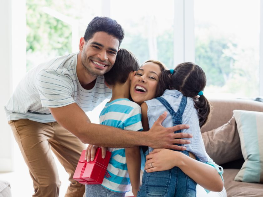 dad and kids giving minimalist mom a gift