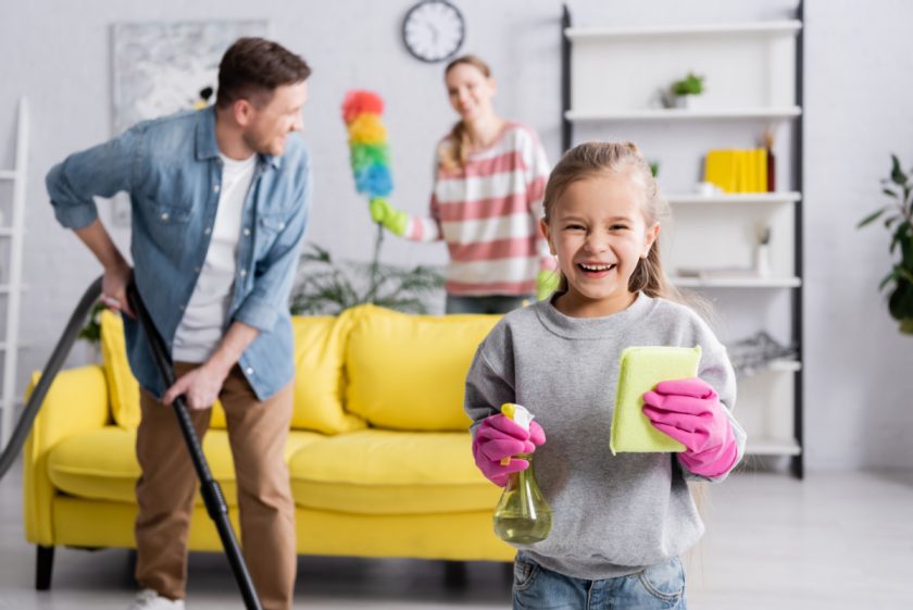 homeschool family - mom, dad, and child - cleaning the house together