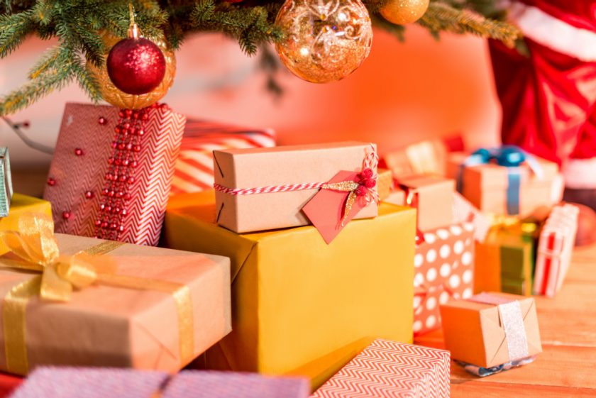 dozens of christmas presents under christmas tree