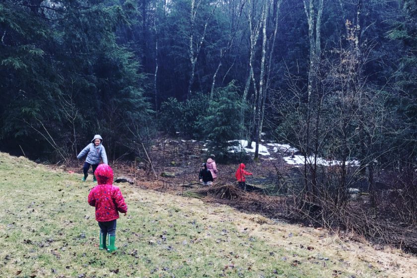 four kids playing outside in winter landscape