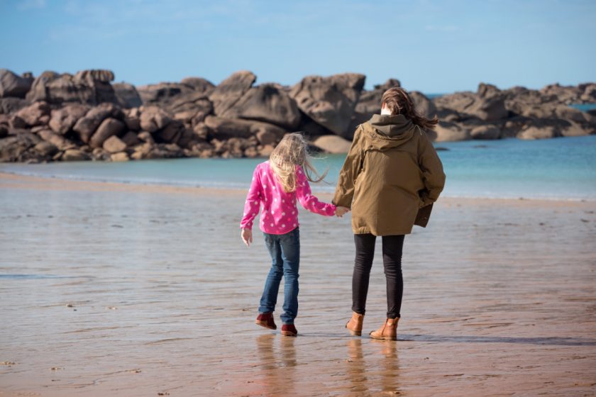 homeschool mom and daughter walking on the beach in winter