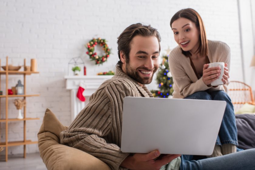 mom and dad looking at the years' photos for their annual christmas tradition