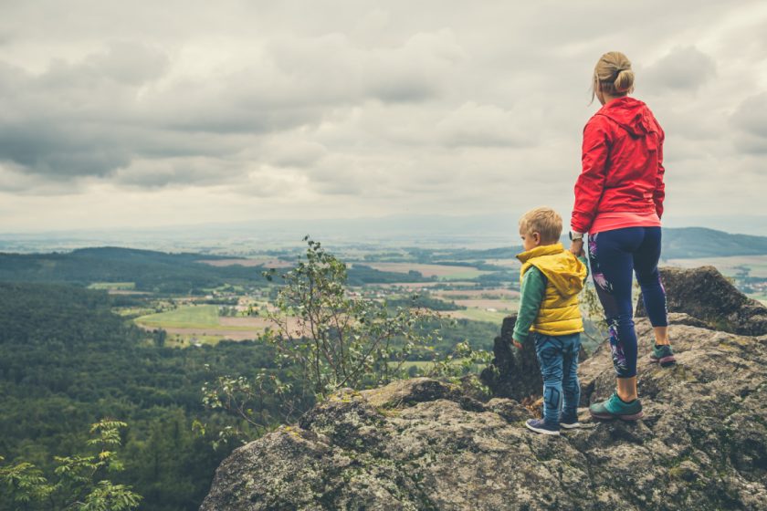 Mother with little boy travelling in mountains. Hiking adventure with child on family trip. Vacations journey with a kid, looking at view.