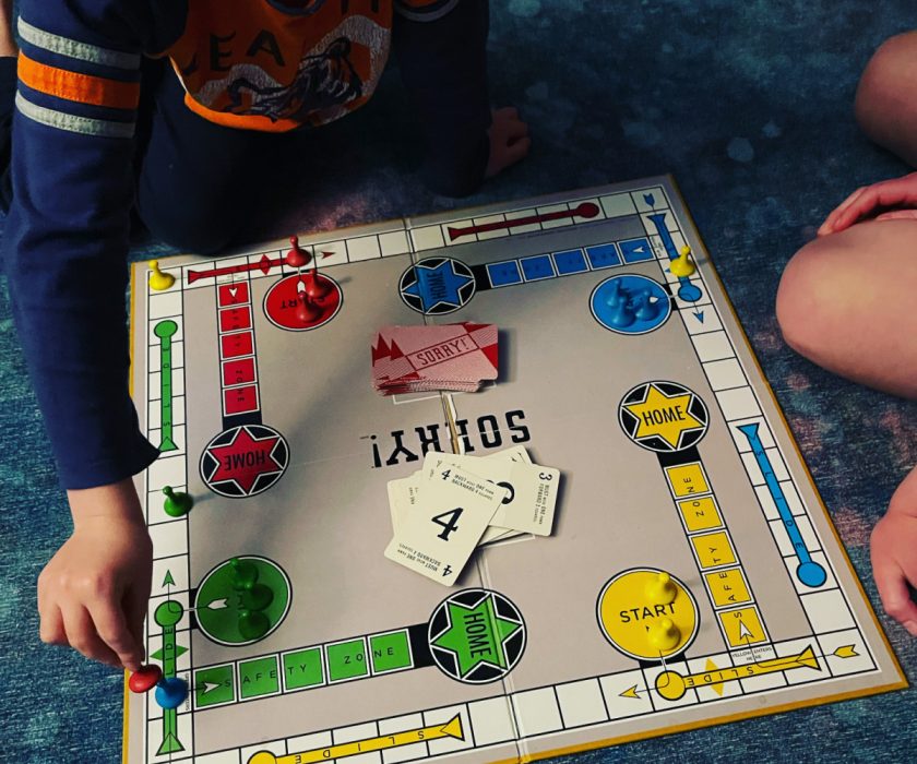 unschooled children playing Sorry board game