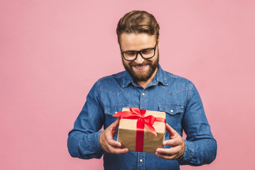 happy minimalist dad looking at gift 