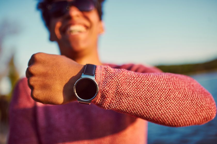 minimalist guy showing off smart watch Christmas gift