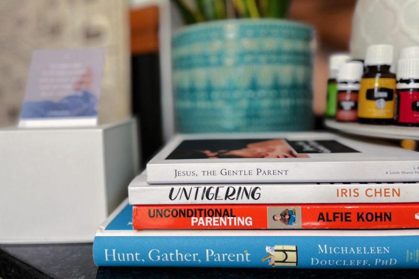 stack of respectful parenting books on counter next to diffuser and plant