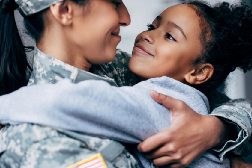 mom and daughter hugging and smiling at each other