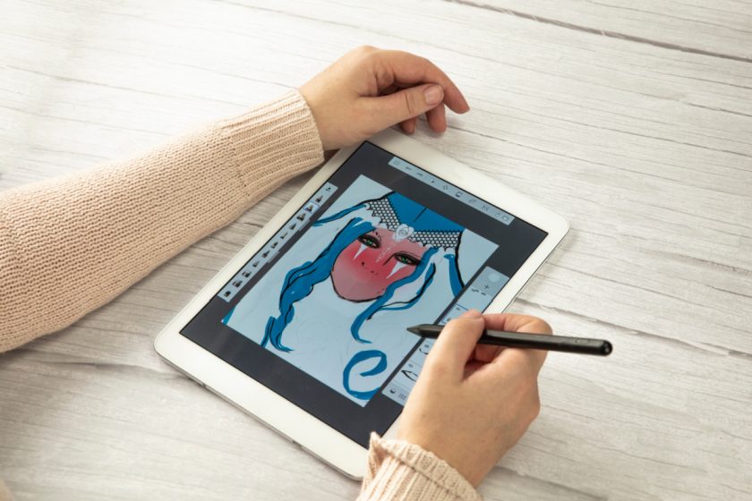 woman drawing digitally on ipad with stylus