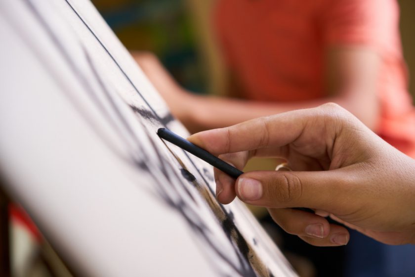 artist sketching using charcoal