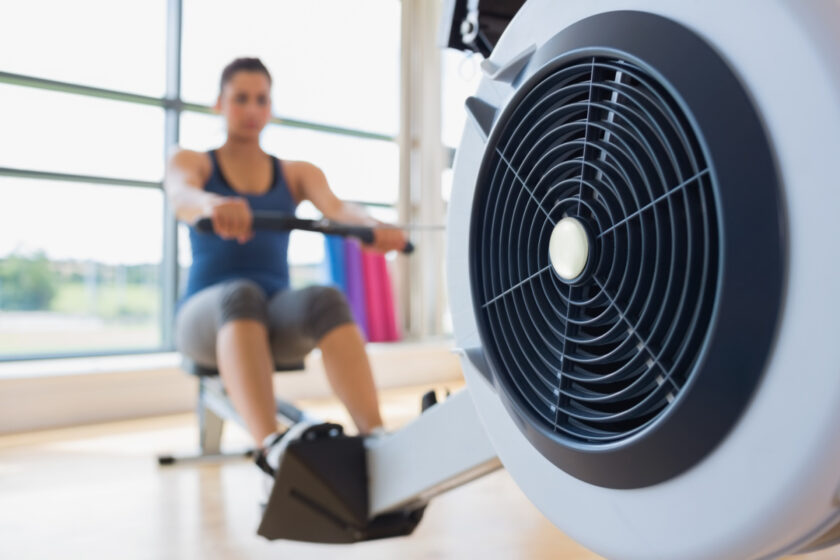 woman on a rowing machine as part of a simple morning routine