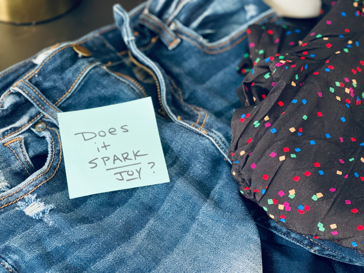 jeans and shirt, with sticky note message, "Does it spark joy?"