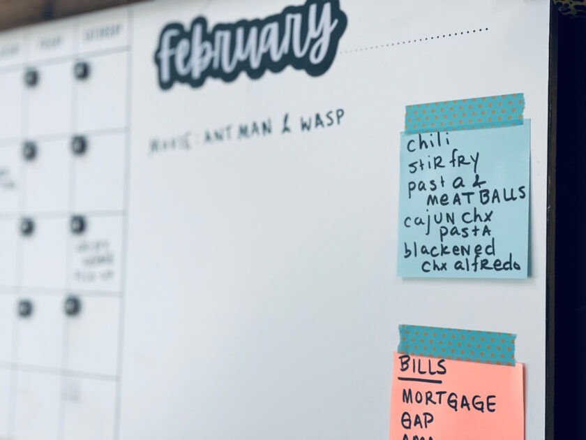 meal plan on sticky note with washi tape, posted on family calendar/message board