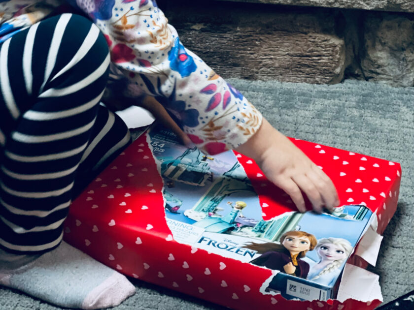 small child opening present